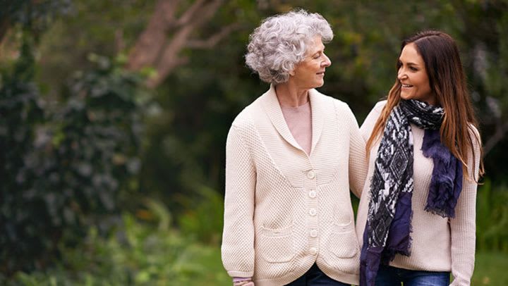 Two women smiling while walking outdoors together