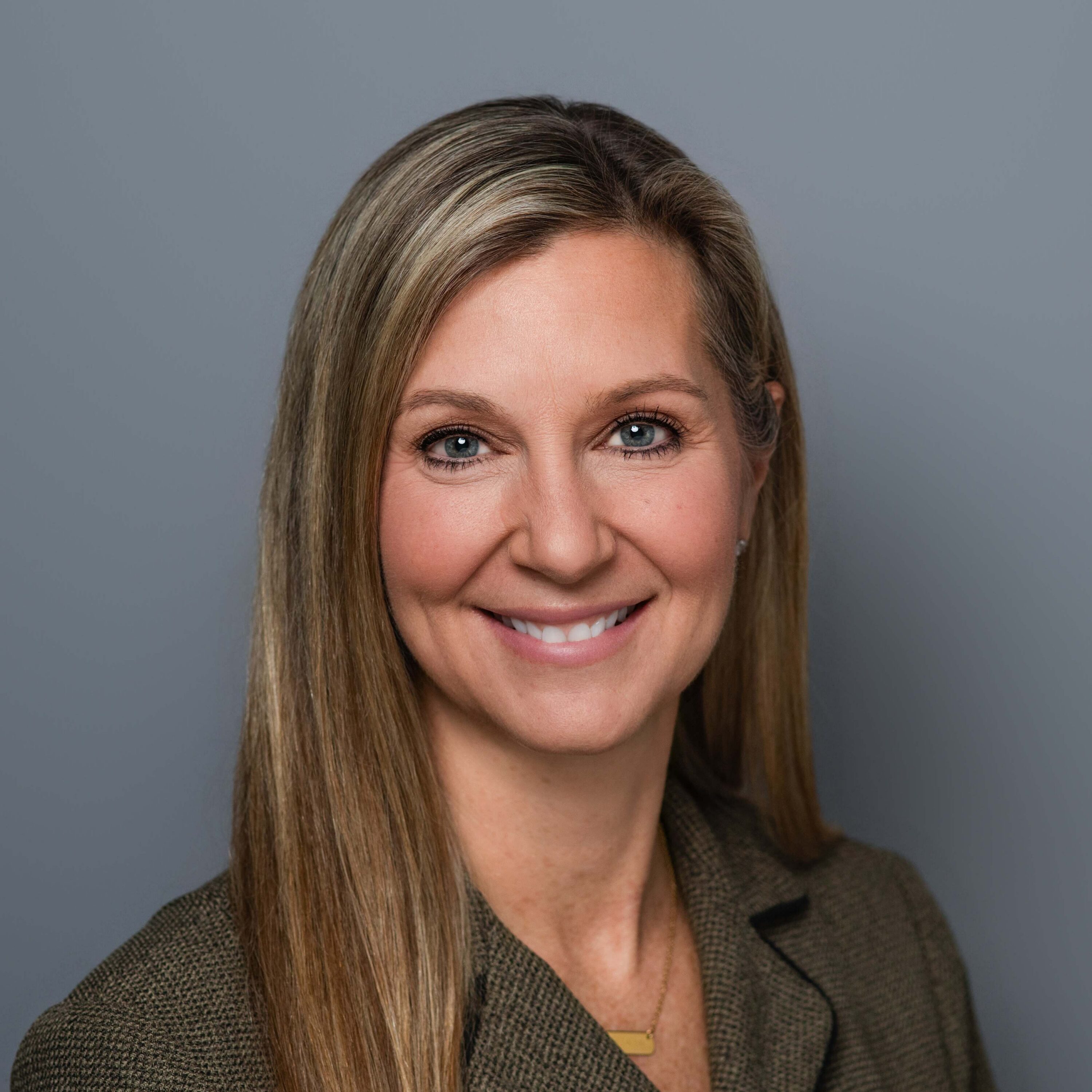 Professional headshot of smiling blonde woman