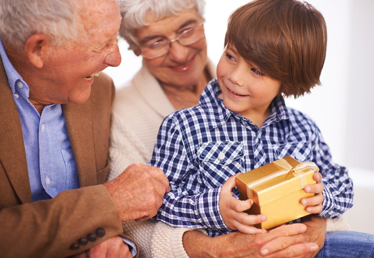 Grandparents and grandson sharing a gift together