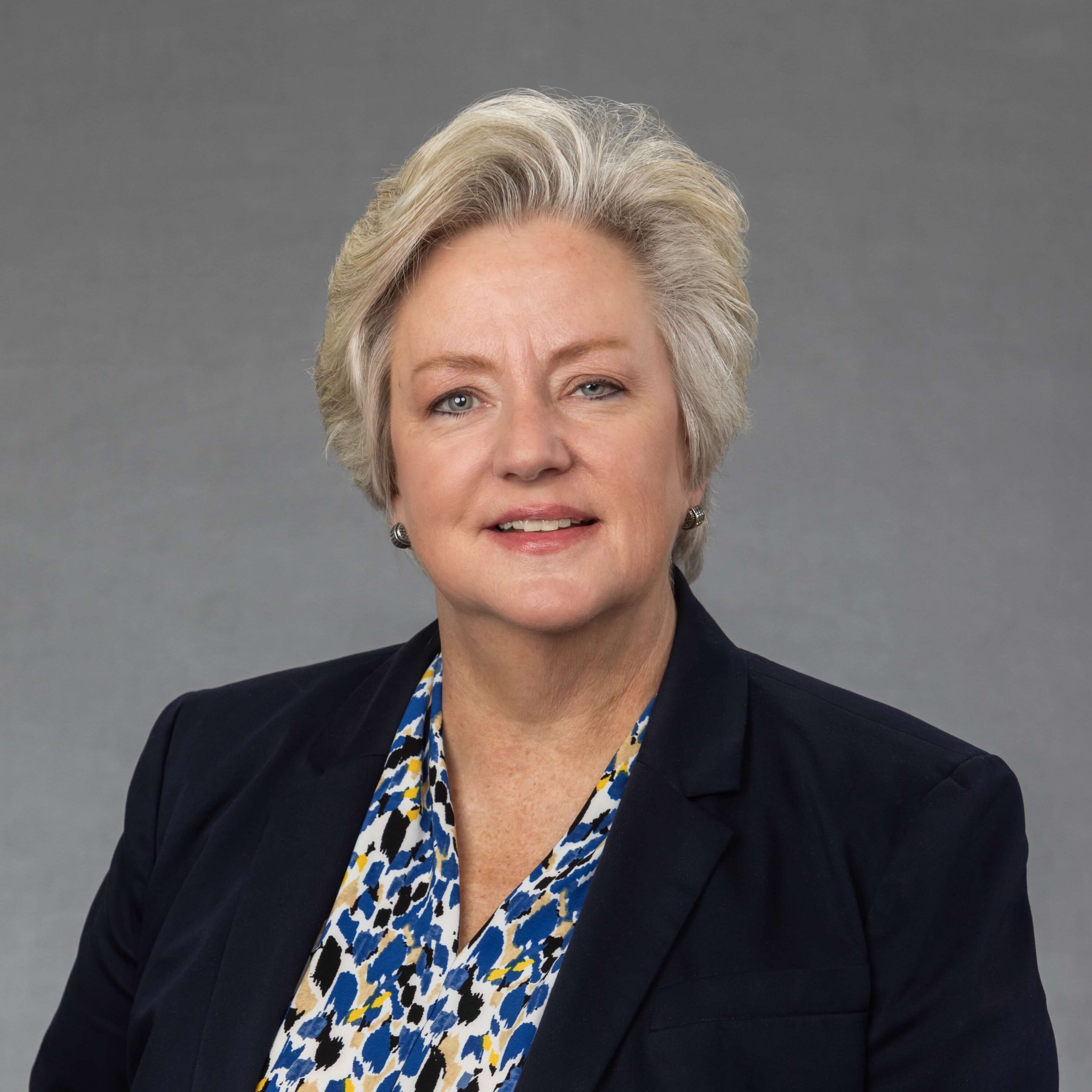 Professional headshot of woman in navy blazer