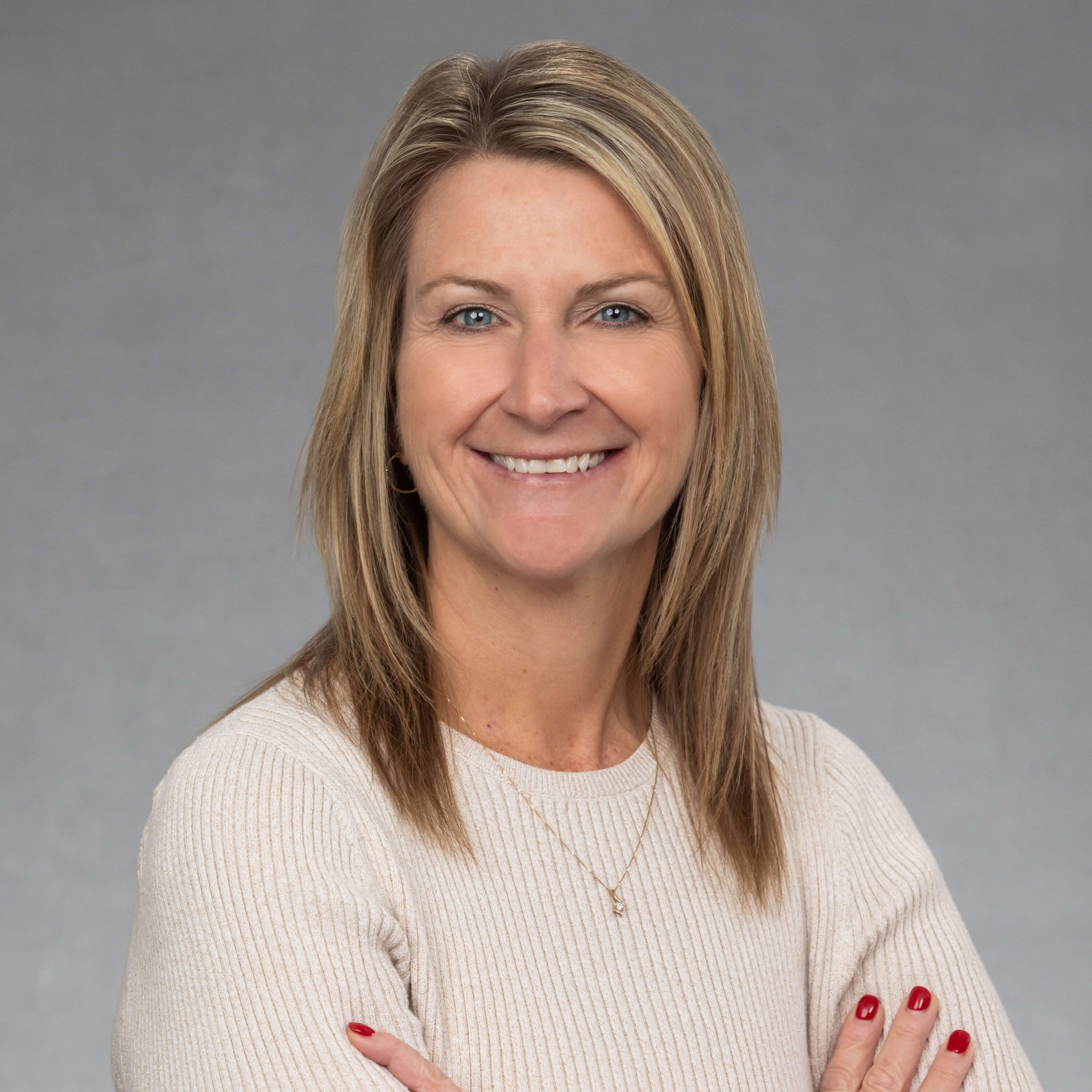 Smiling woman with blonde hair in studio portrait