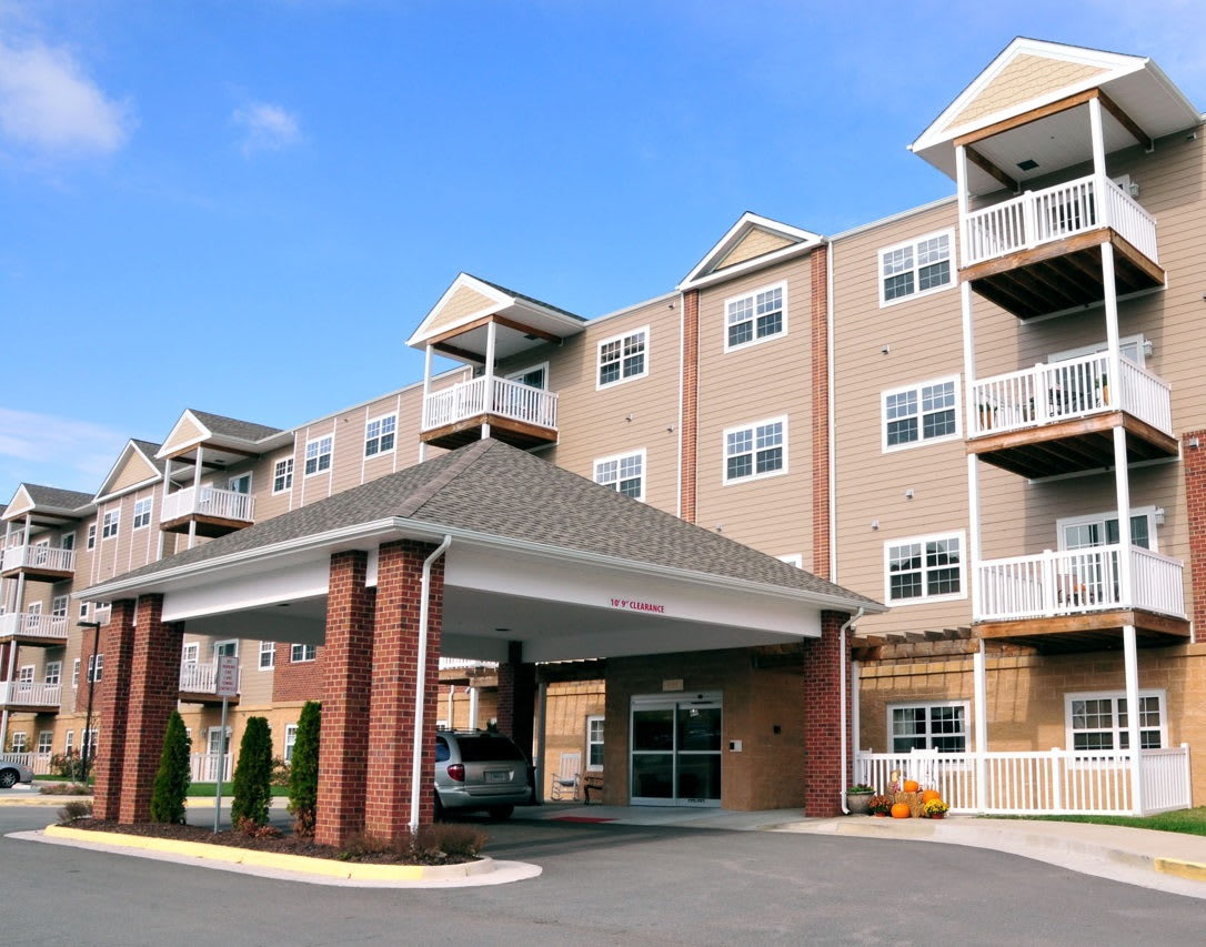 Modern apartment building with balconies and covered entrance