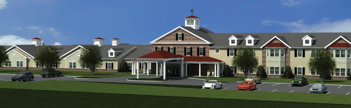 Large residential building with covered entrance and parking lot