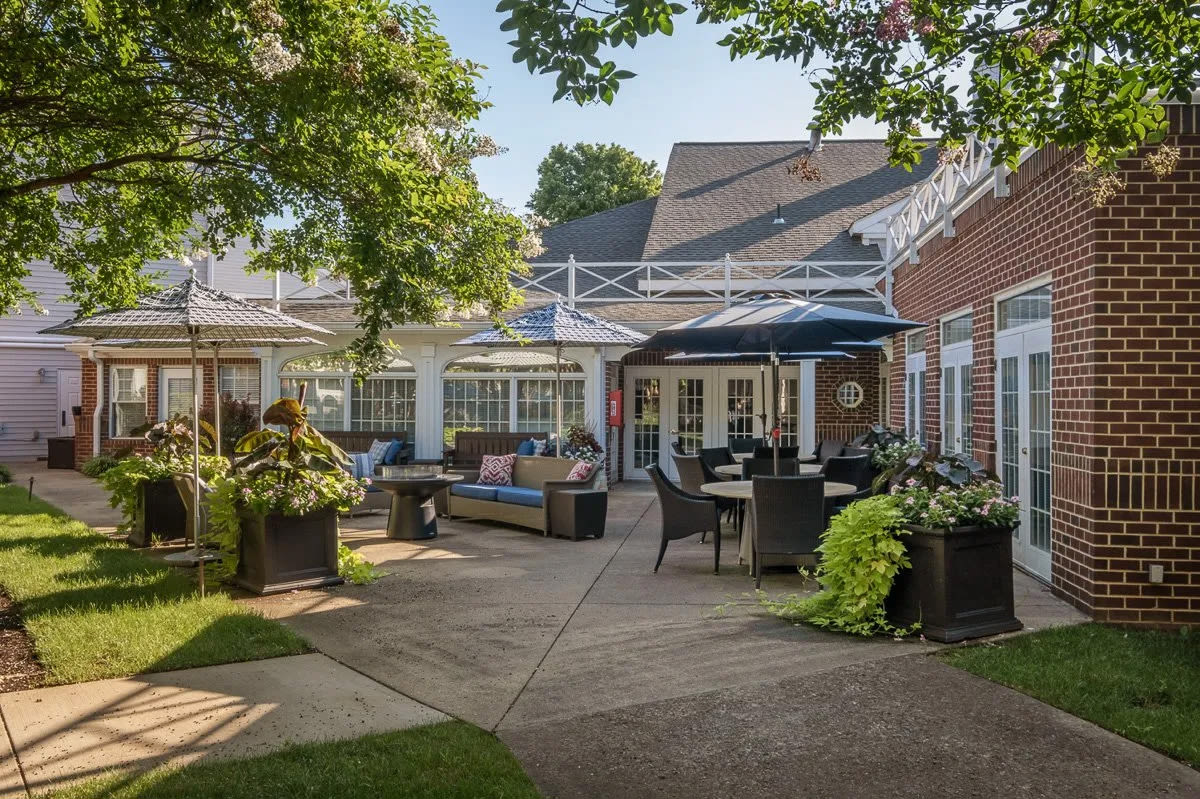 Landscaped patio courtyard with outdoor seating and umbrellas
