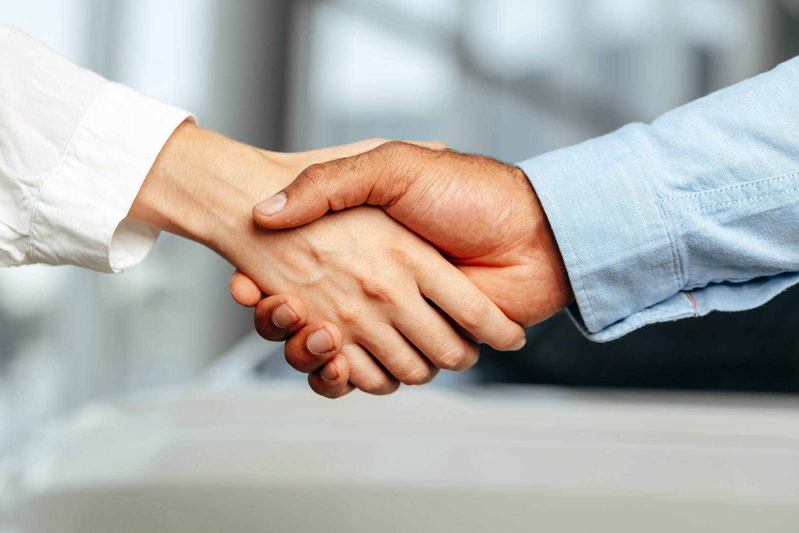 Close-up of business handshake across desk