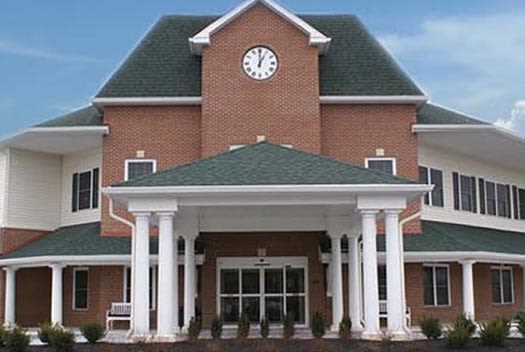 Brick building with clock and white columns