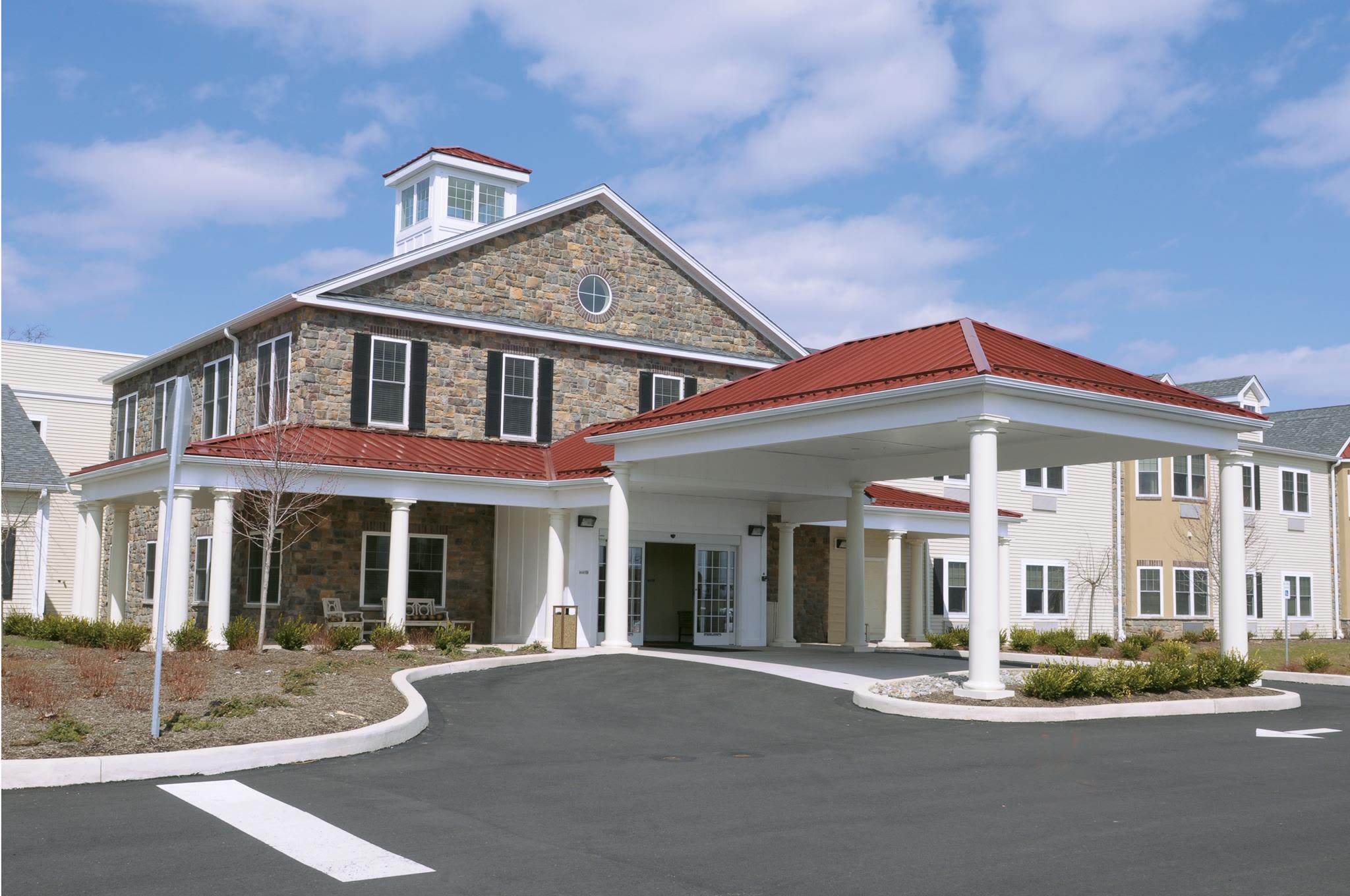 Stone building with red roof and columns