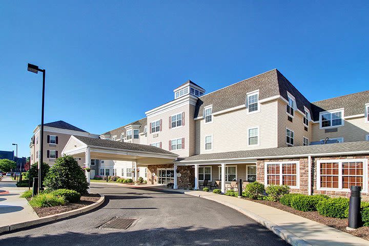Modern hotel exterior with covered entrance driveway