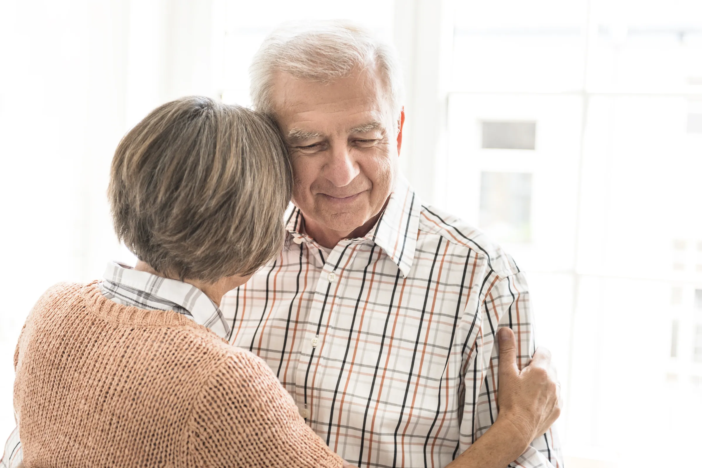 Senior couple sharing a warm embrace indoors